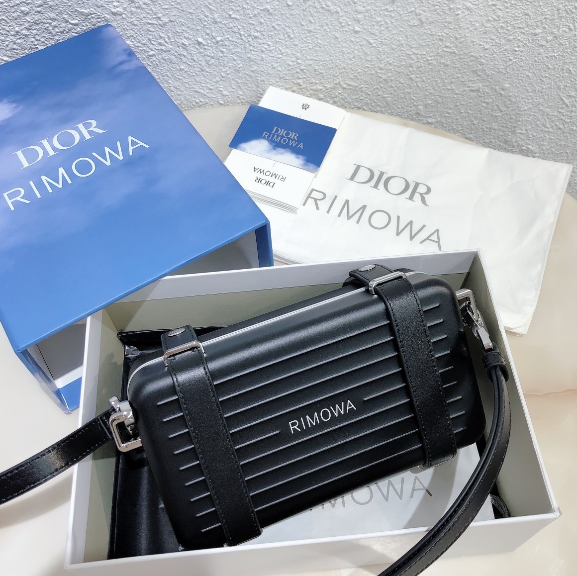 D*or and rimowa black trunk