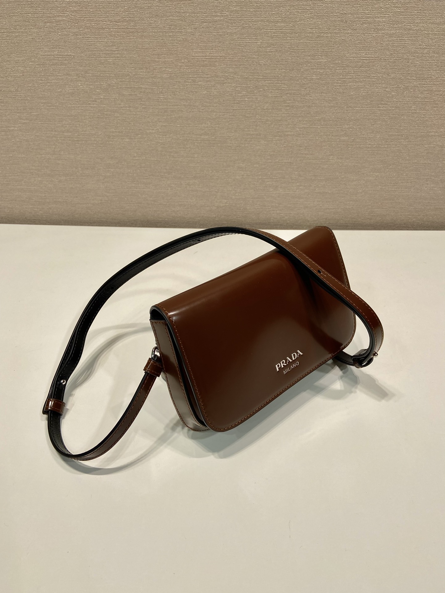 Pra*a brushed leather mini-bag with shoulder strap