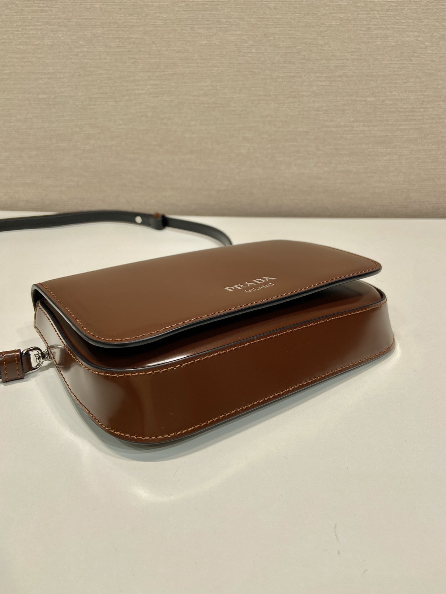 Pra*a brushed leather mini-bag with shoulder strap
