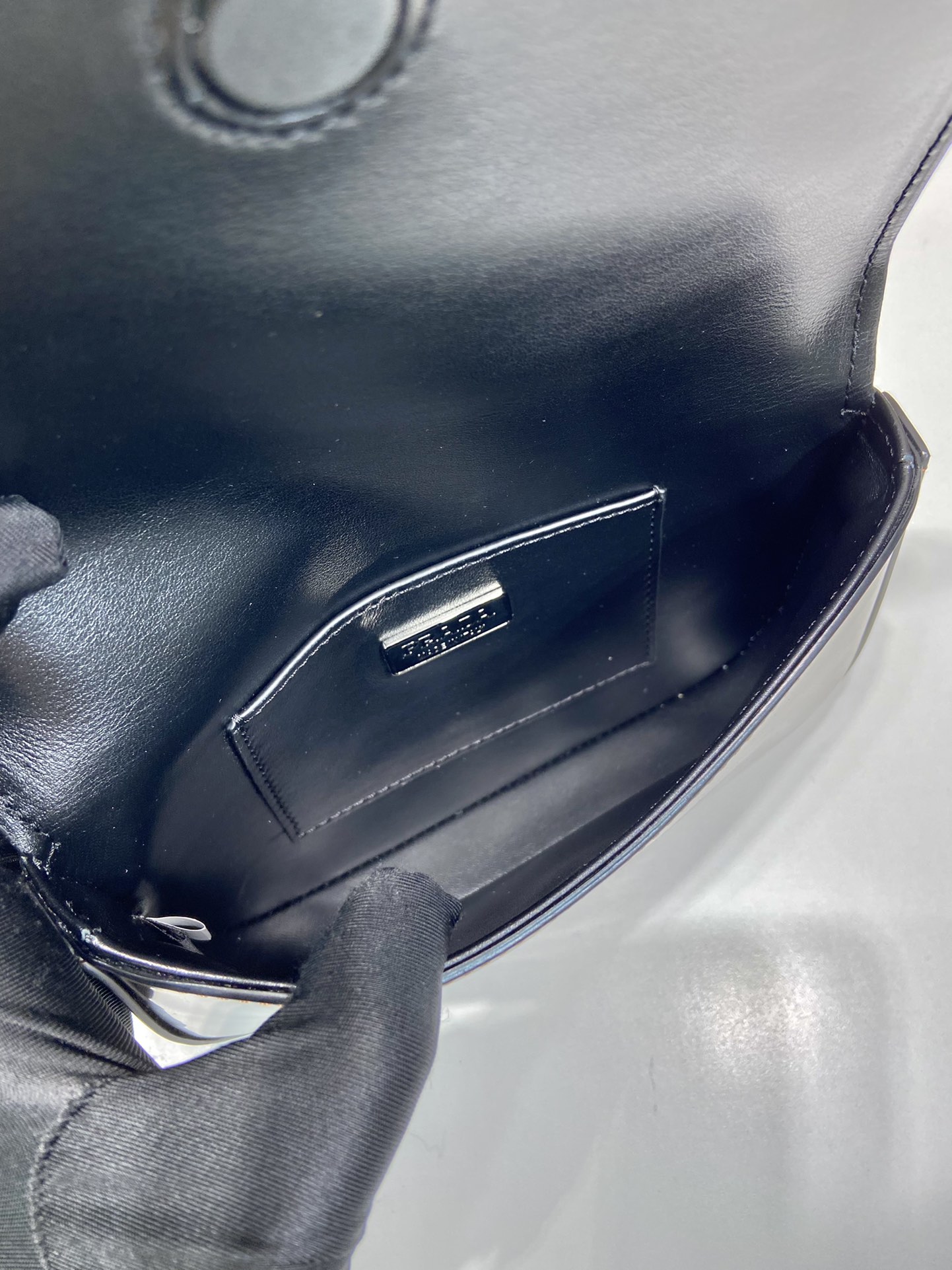 Pra*a brushed leather mini-bag with shoulder strap