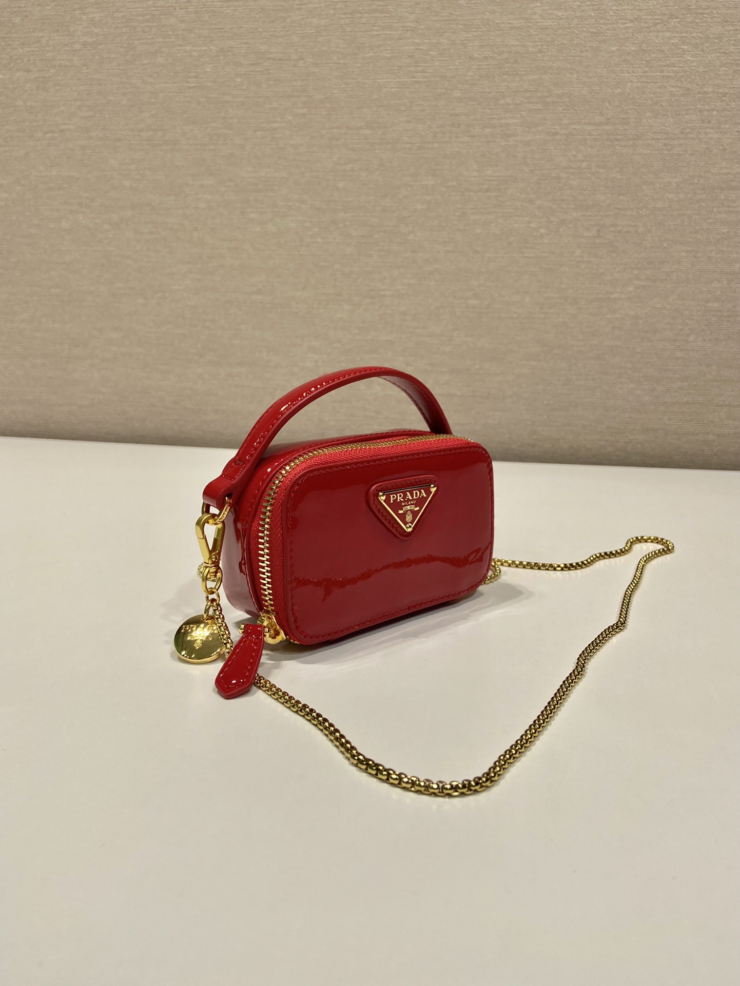 Pra*a patent leather mini-pouch