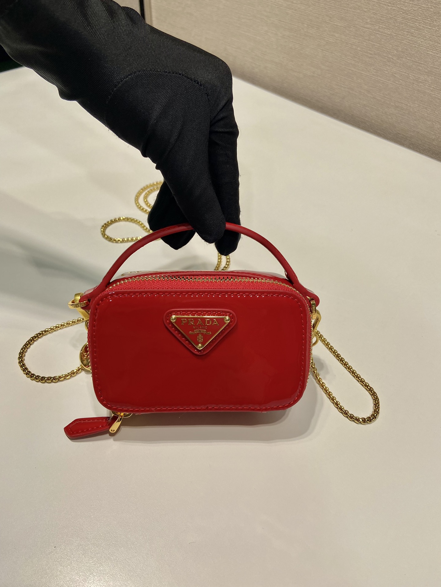 Pra*a patent leather mini-pouch